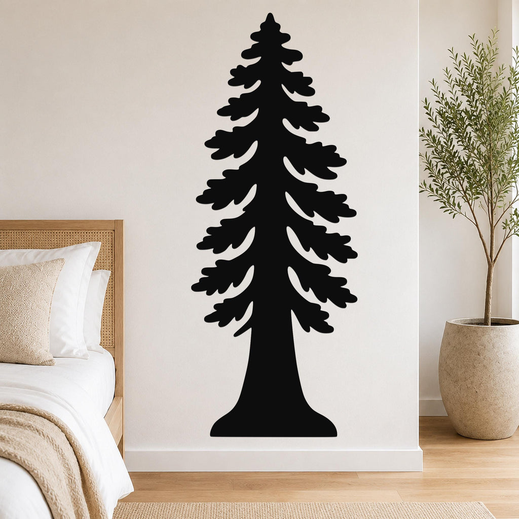 Black metal redwood tree wall art with layered branch cutouts, mounted on a bedroom wall above a bed.