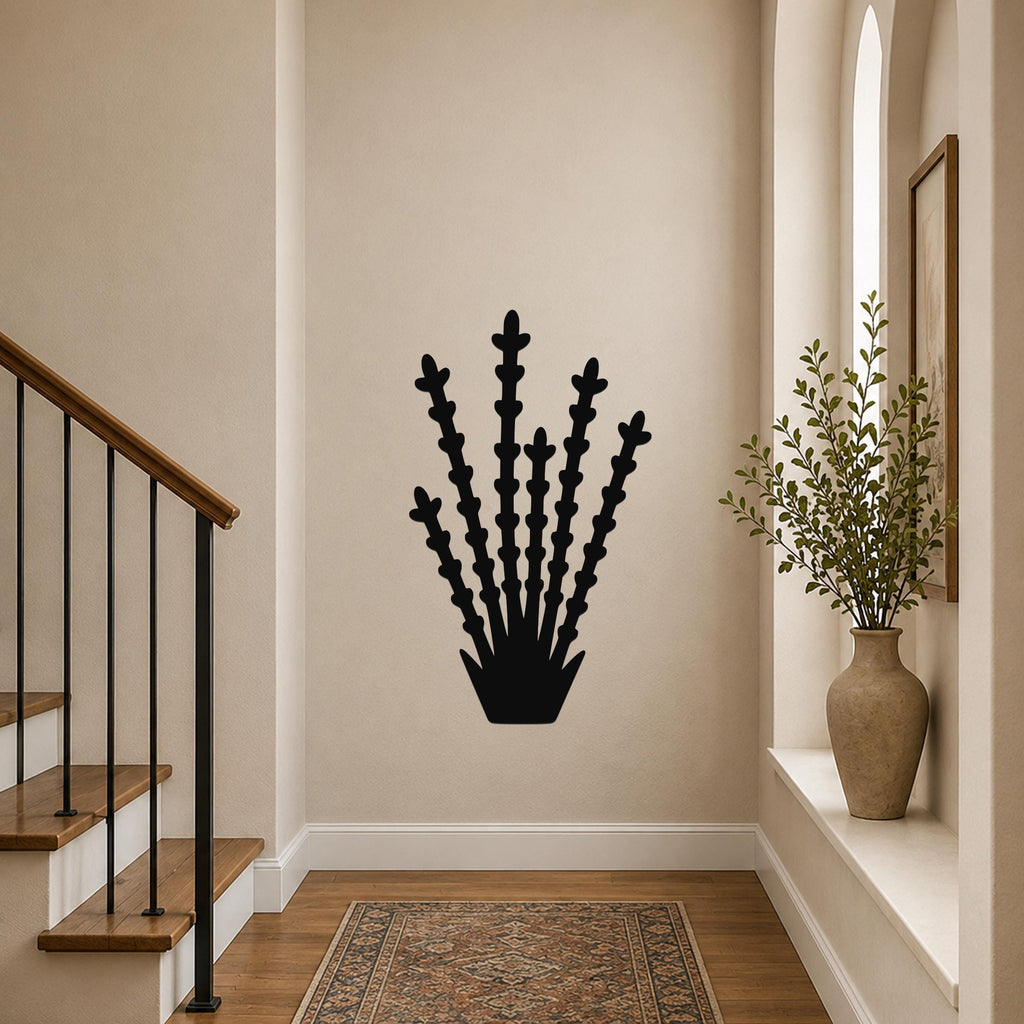 Black metal ocotillo wall art with branching cutouts, mounted on a hallway wall above a patterned rug near a staircase.