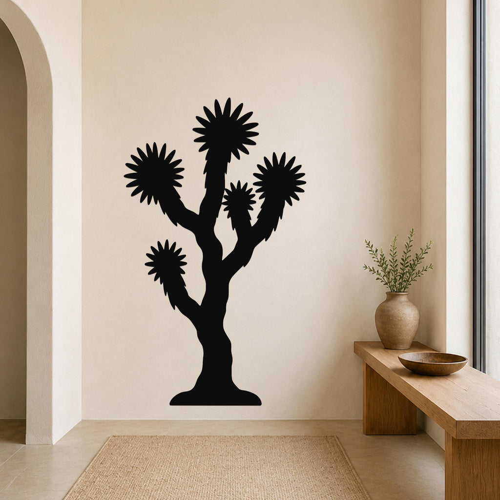 Black metal Joshua tree wall art with starburst-shaped branches, mounted on a beige wall above a wooden bench in a modern entryway.