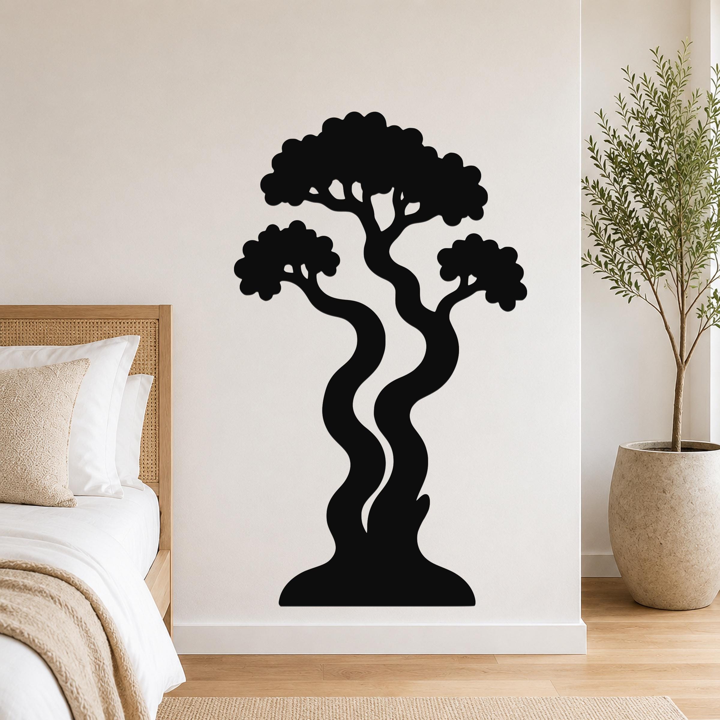 Black metal wall art in a bonsai tree silhouette with wavy trunks and layered canopy, mounted on a bedroom wall above a bed.