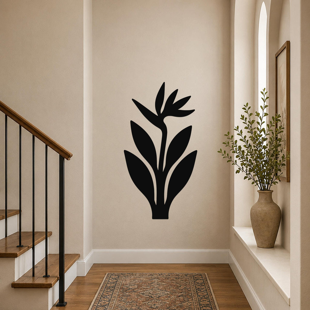 Black metal wall art in a Bird of Paradise silhouette, mounted on a hallway wall above a patterned rug near a staircase.