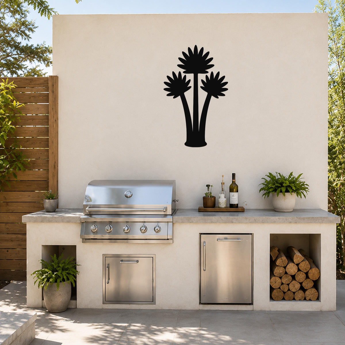 Black metal palm tree wall art with three fan-shaped fronds, mounted on a beige outdoor wall above a kitchen counter.