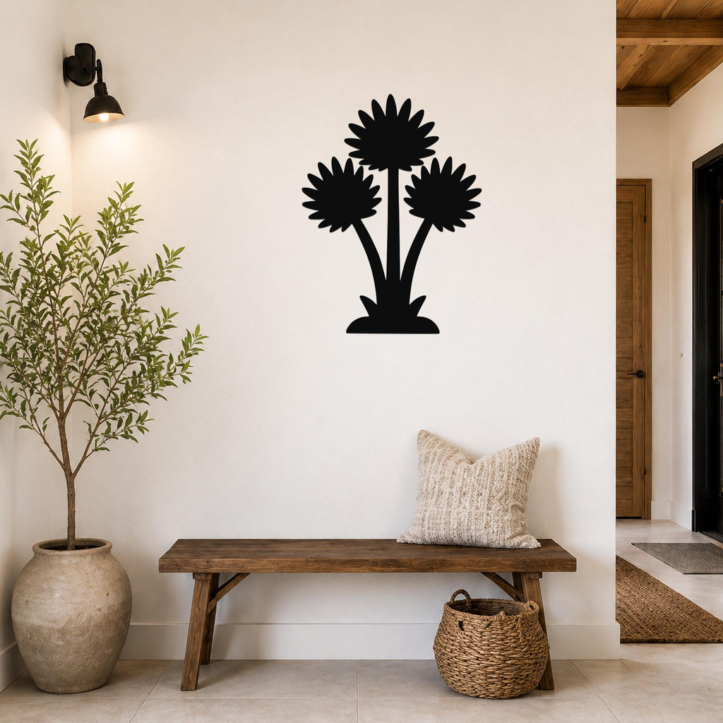 Black metal wall art featuring a silhouette of three wildflowers, mounted on a white wall above a wooden bench in a living room.