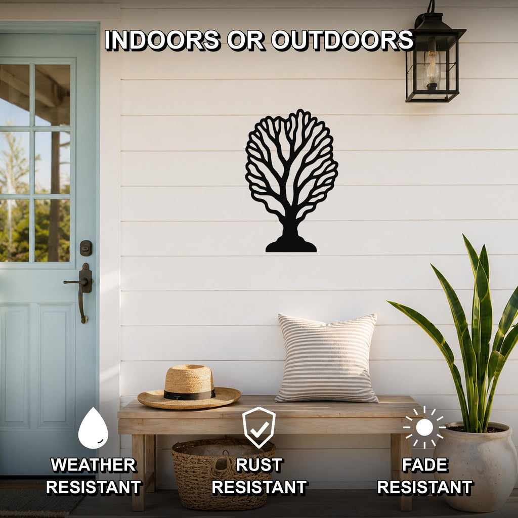 Black metal fan coral wall art with intricate branch cutouts, mounted on a white shiplap wall above a wooden bench on a porch.