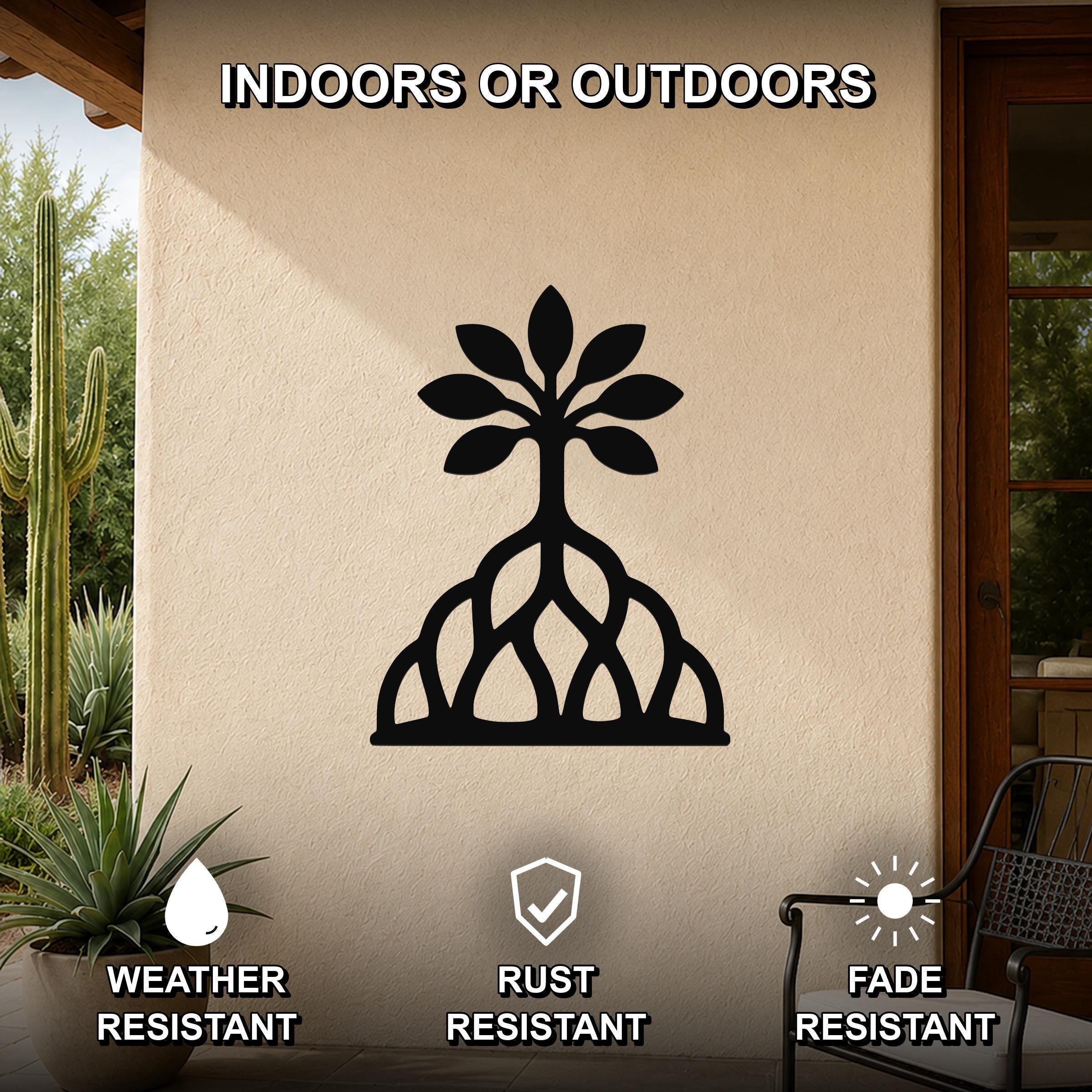 Black metal wall art featuring a tree silhouette with visible root cutouts, mounted on an outdoor patio wall.