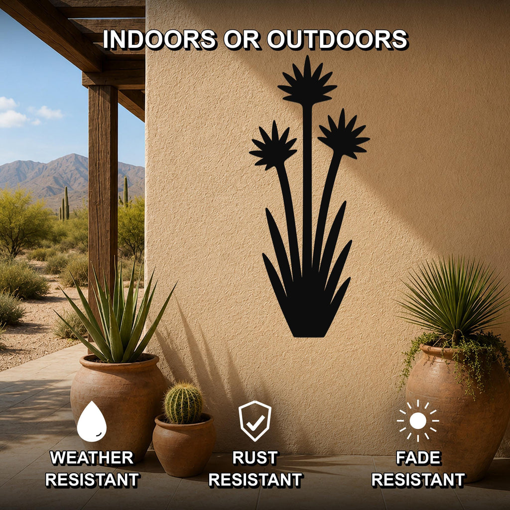 Black metal yucca wall art with blooming flower cutouts, mounted on an outdoor patio wall above potted plants, weather, rust, and fade resistant.
