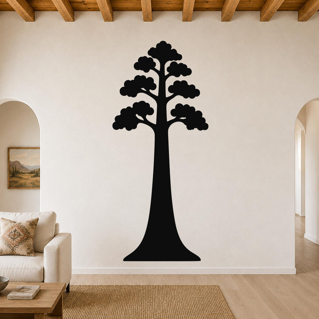 Black metal sequoia tree wall art with layered canopy cutouts, mounted on a living room wall above a sofa.