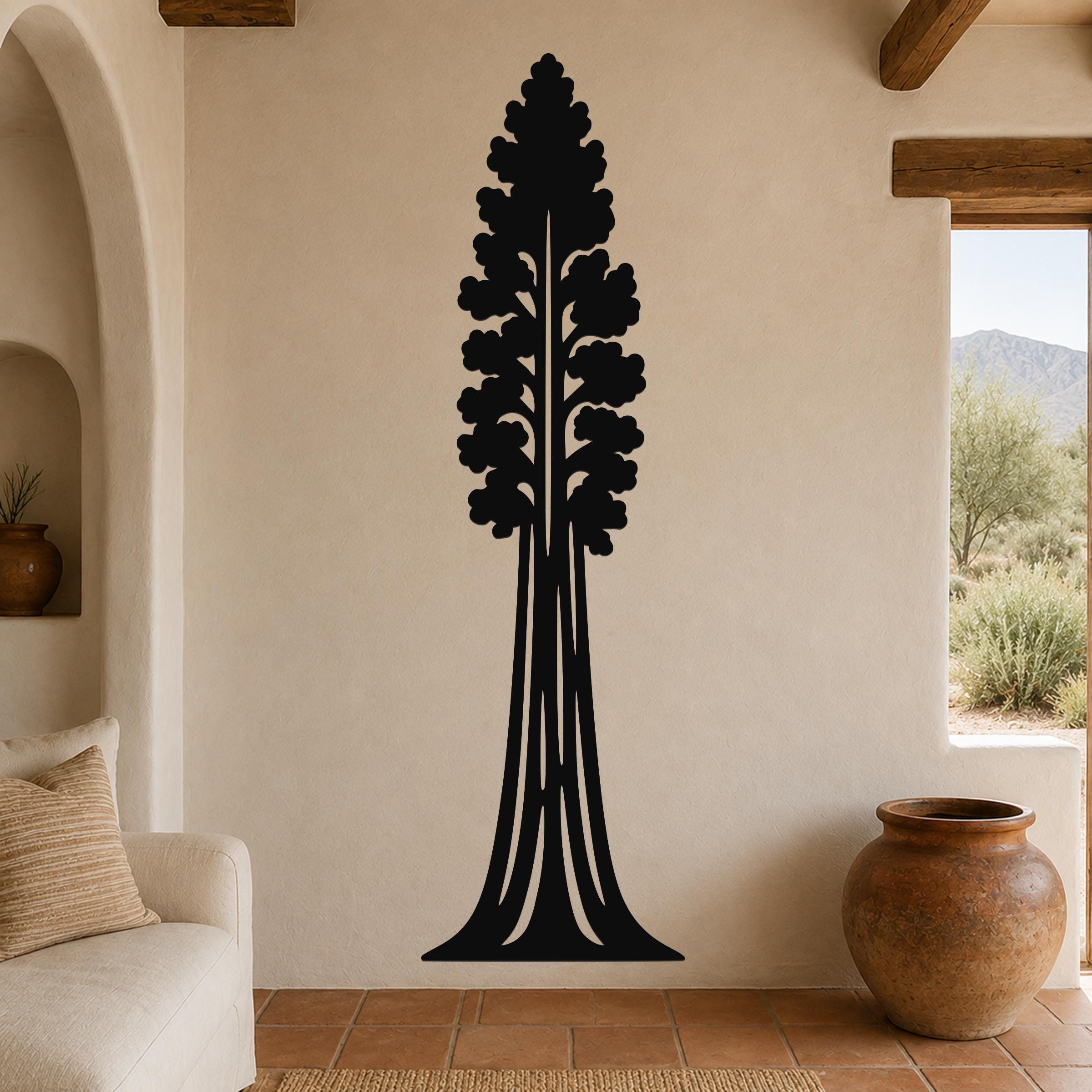 Black metal sequoia tree wall art with detailed branch cutouts, mounted on a beige living room wall above a sofa.