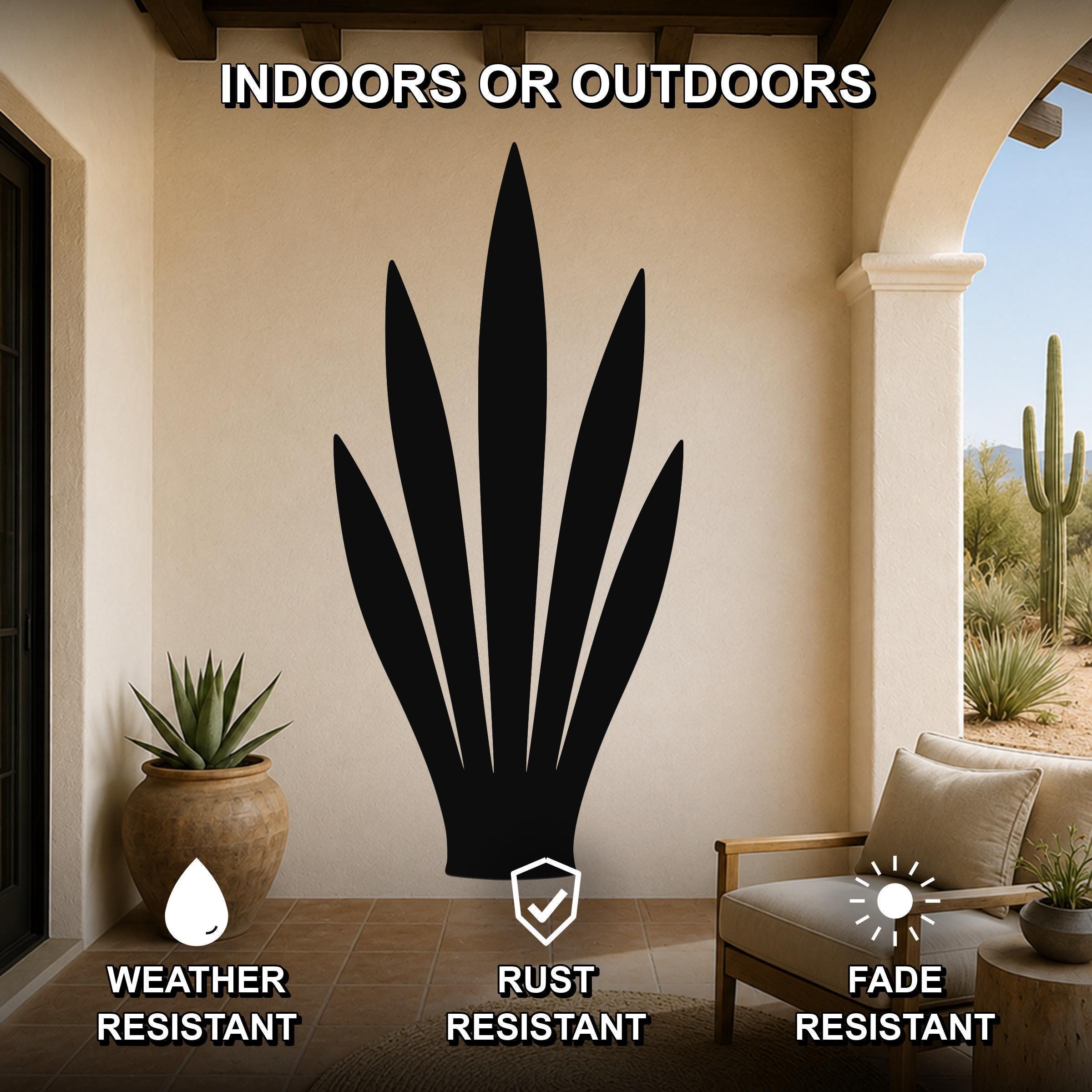 Black metal snake plant wall art silhouette mounted on a beige patio wall, displayed above a wooden chair in a covered outdoor living space.