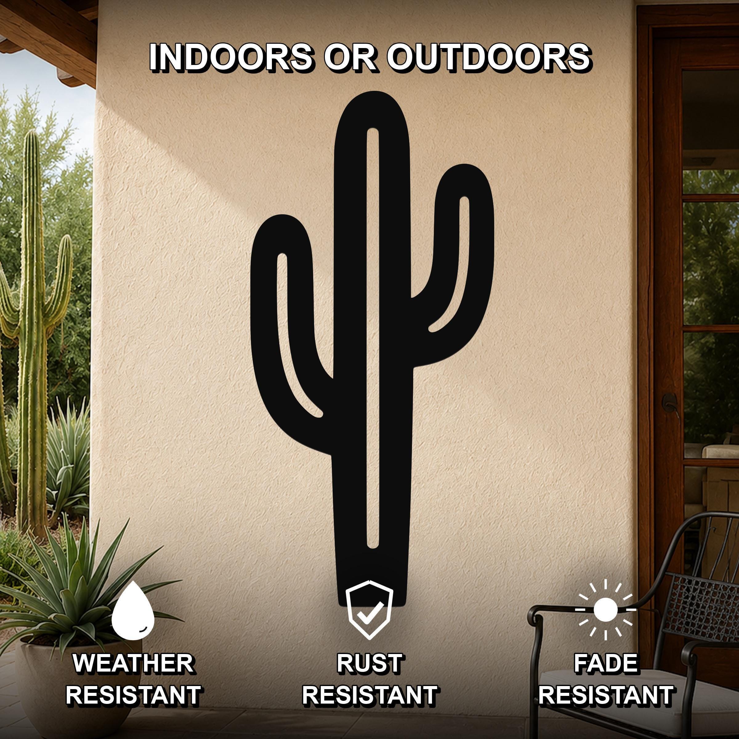 Black metal saguaro cactus wall art with cutout branches, mounted on an outdoor patio wall.