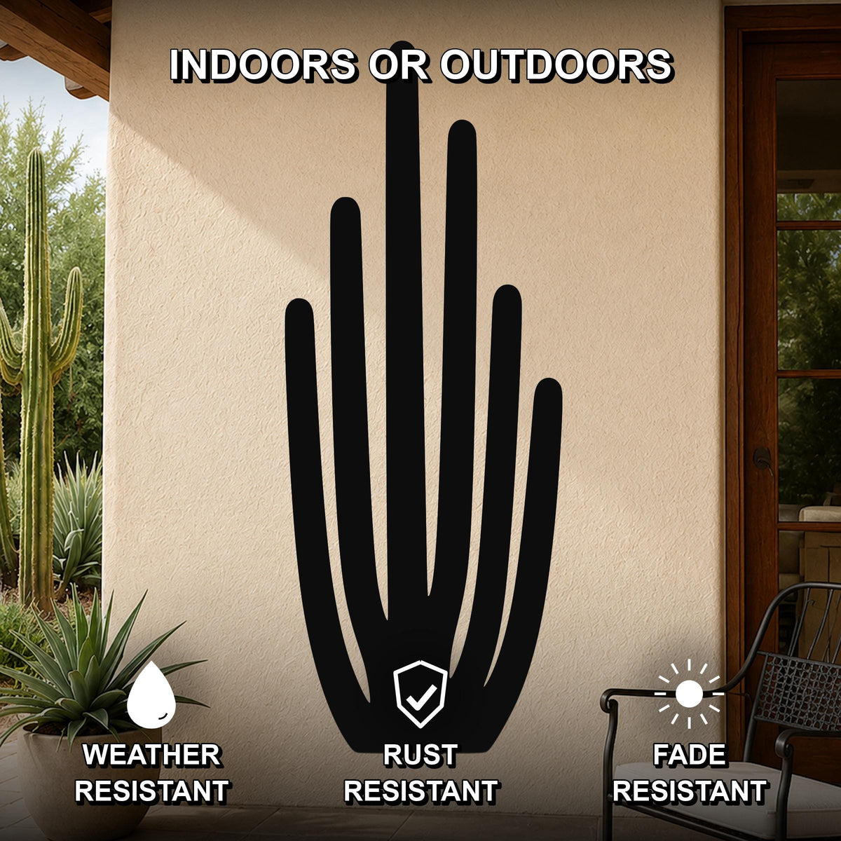 Black metal organ pipe cactus wall art with vertical spine cutouts, mounted on an outdoor patio wall above a potted plant.