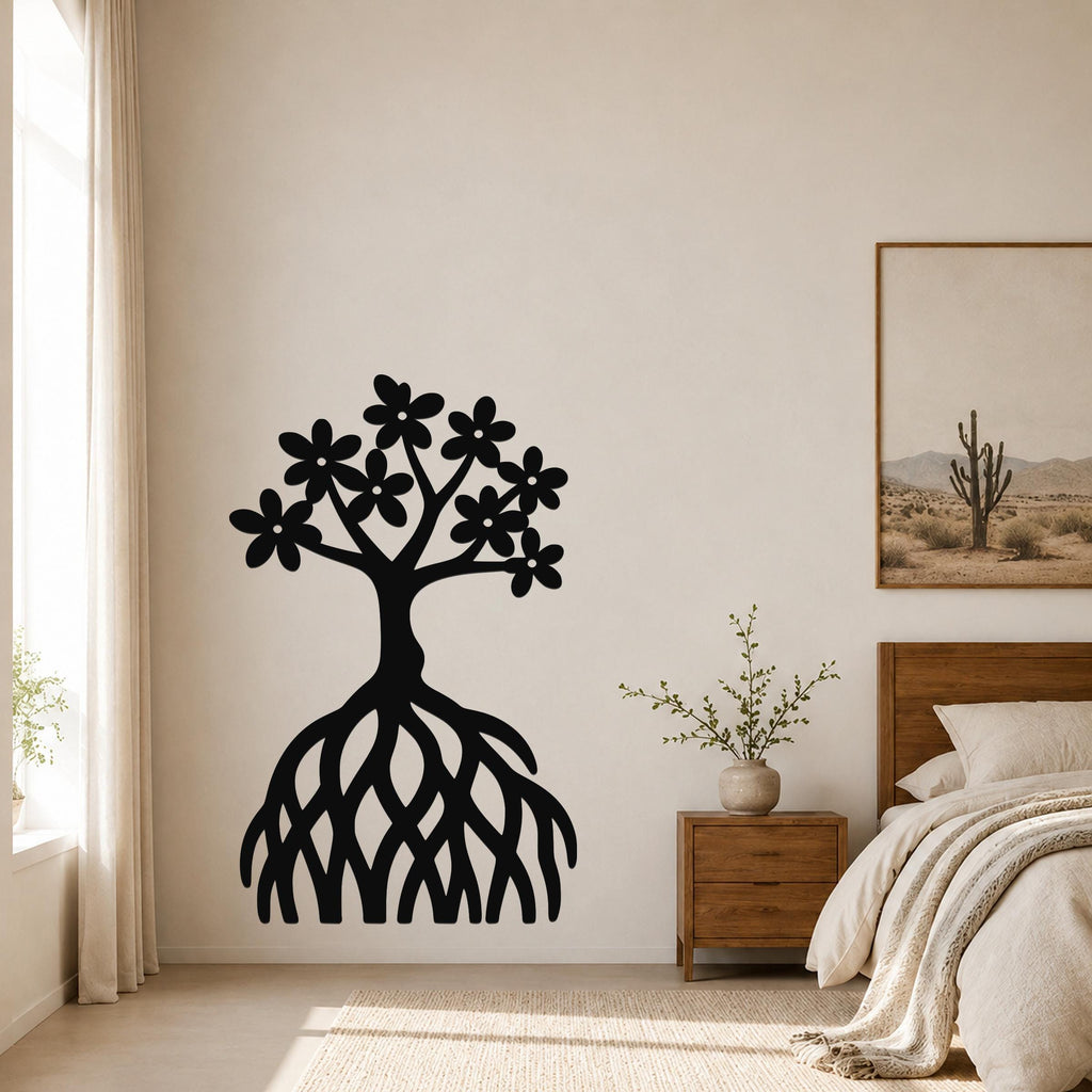 Black metal wall art of a tree with flower-shaped leaves and exposed roots, mounted on a bedroom wall above a wooden nightstand.