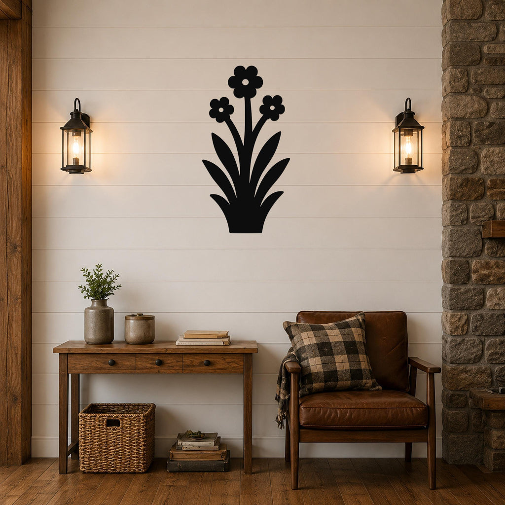 Black metal wildflower wall art with three blossoms and leaf cutouts, mounted on a shiplap wall above a wooden console table in a living room.