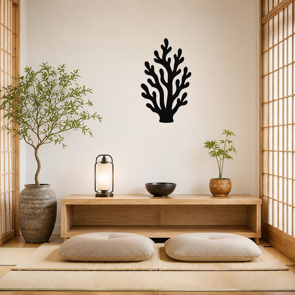 Black metal coral wall art with branching cutouts, mounted on a beige wall above a wooden console in a minimalist living room.