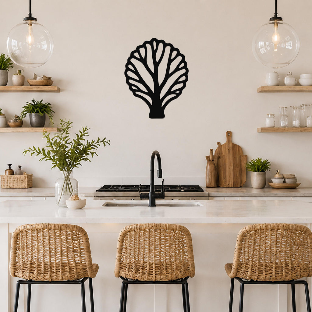 Black metal fan coral wall art with intricate cutout branches, mounted on a kitchen wall above a counter.