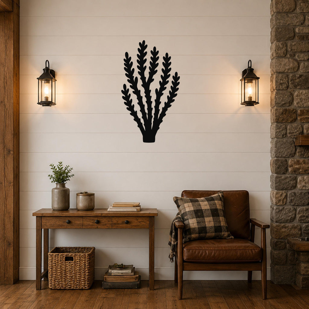 Black metal wall art in a desert branch silhouette, mounted on a shiplap wall above a wooden console table in a living room.