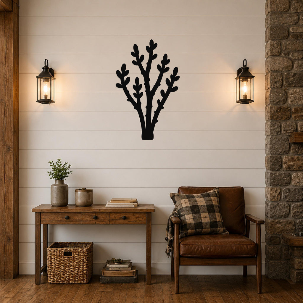 Black metal wall art in a desert branch silhouette, mounted on a shiplap wall above a wooden console table in a living room.