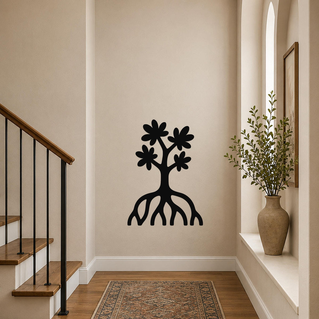 Black metal wall art in the shape of a tree with flowers and exposed roots, mounted on a hallway wall above a patterned rug.