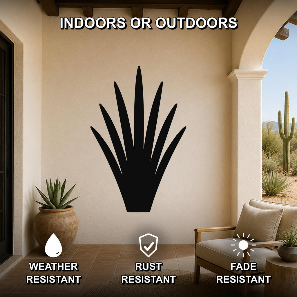 Black metal yucca wall art silhouette mounted on a beige patio wall, displayed above a wooden chair with cushions and a potted plant nearby.