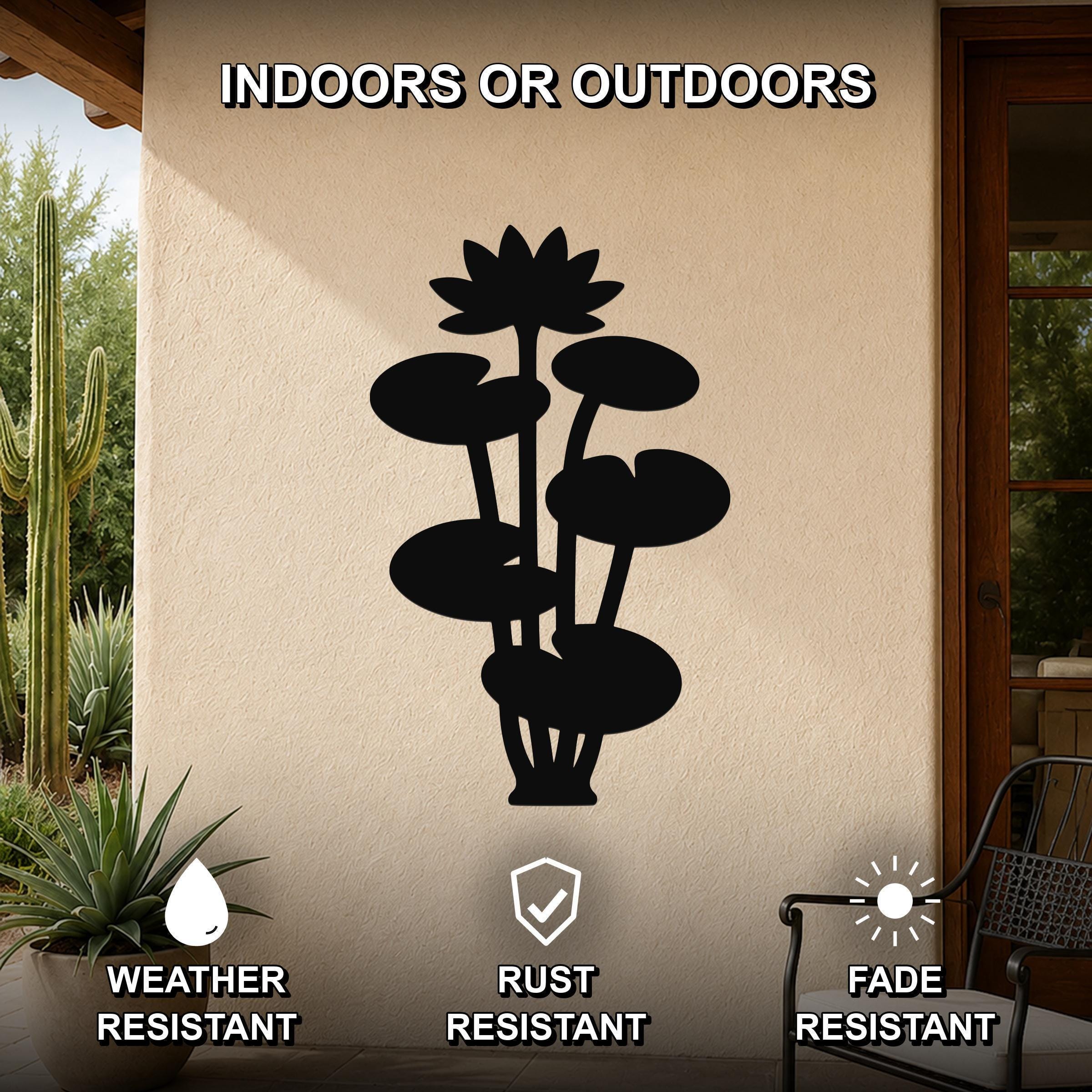 Black metal lotus water lily wall art with layered flower and leaf cutouts, mounted on an outdoor patio wall above a potted plant.