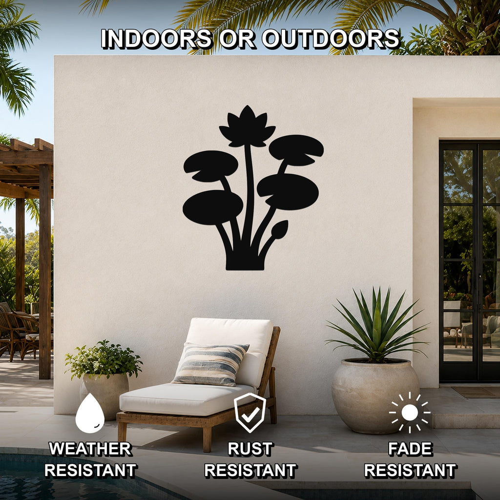 Black metal lotus water lily wall art with leaf and flower cutouts, mounted on an outdoor patio wall above a lounge chair.