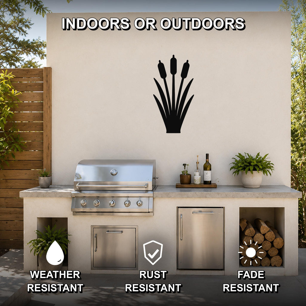 Black metal cattail wall art silhouette mounted on an outdoor patio wall above a stainless steel grill and counter.