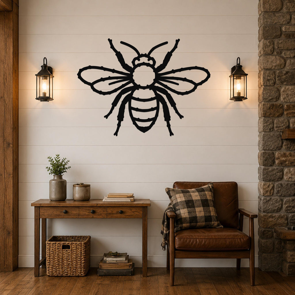 Black metal bee wall art with detailed cutout wings and legs, mounted on a shiplap wall above a wooden console table in a living room.
