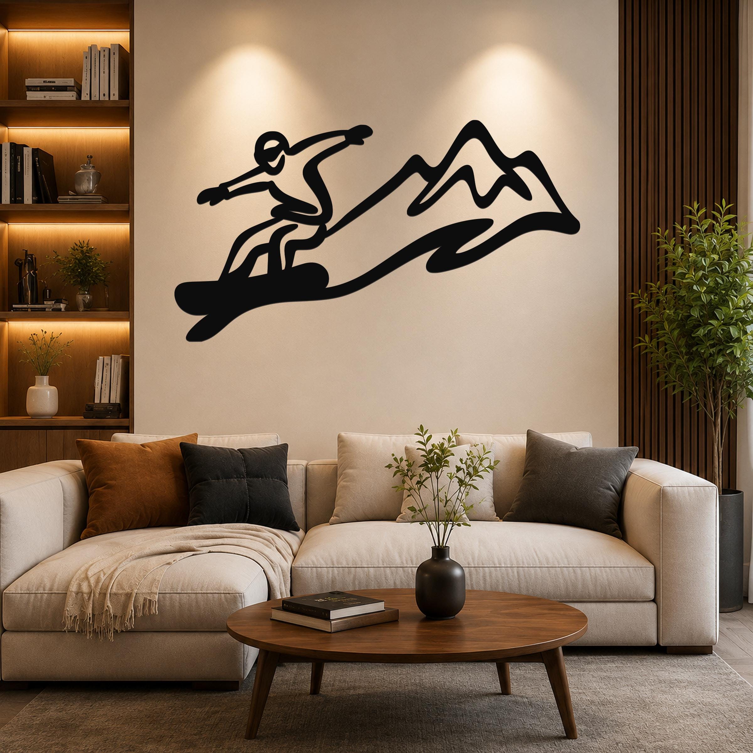 Black metal wall art silhouette of a snowboarder in motion above a sofa in a living room.