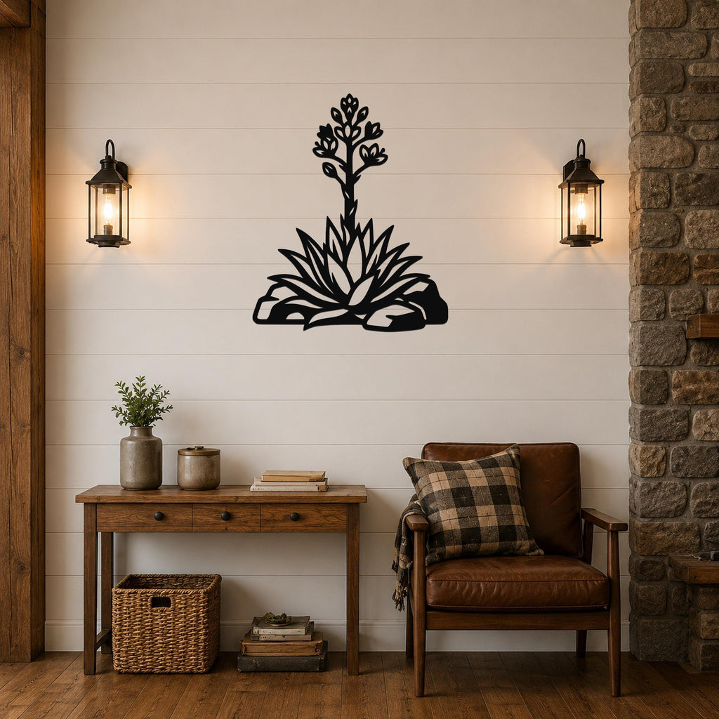 Black metal agave wall art with blooming flower cutout, mounted on a shiplap wall above a wooden console table in a living room.