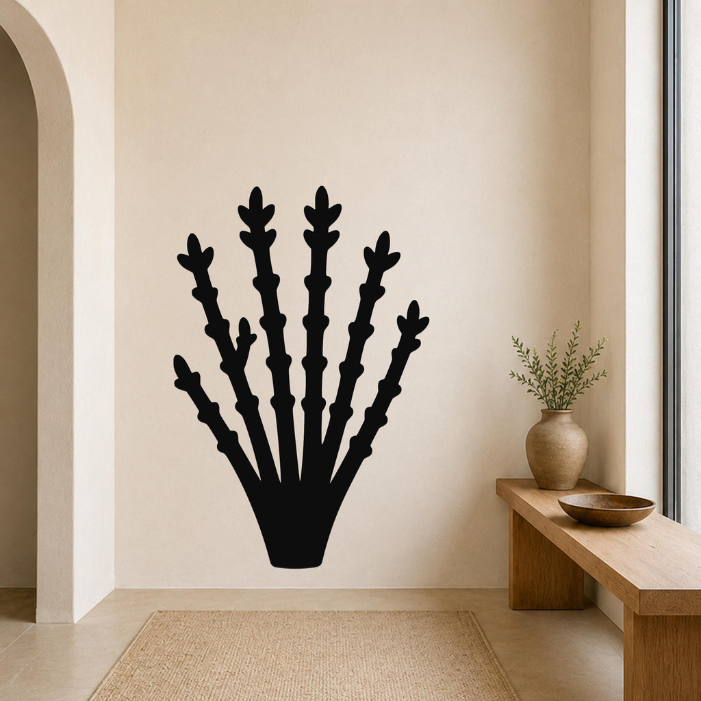 Black metal ocotillo wall art with branching cutouts, mounted on a beige wall above a wooden bench in a minimalist entryway.