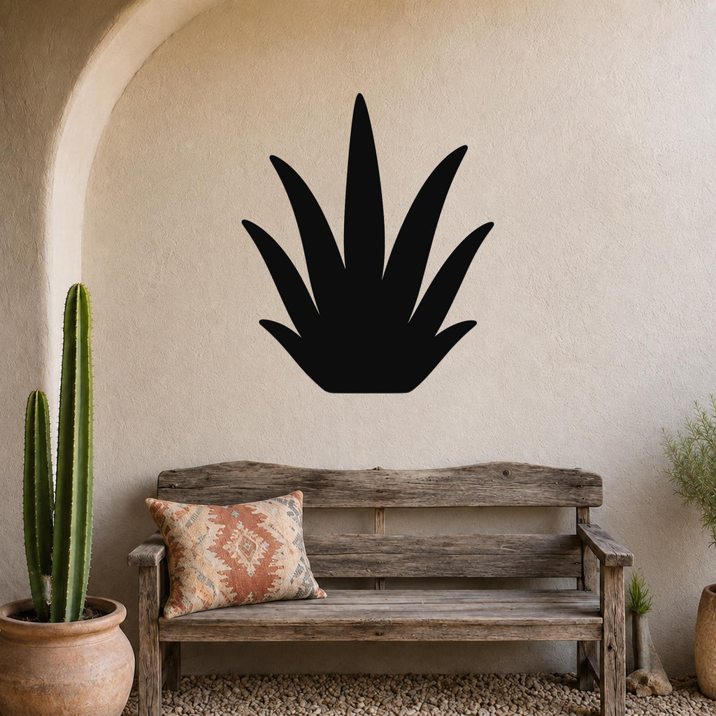 Black metal agave wall art silhouette mounted on a textured beige wall above a rustic wooden bench in a patio entryway.