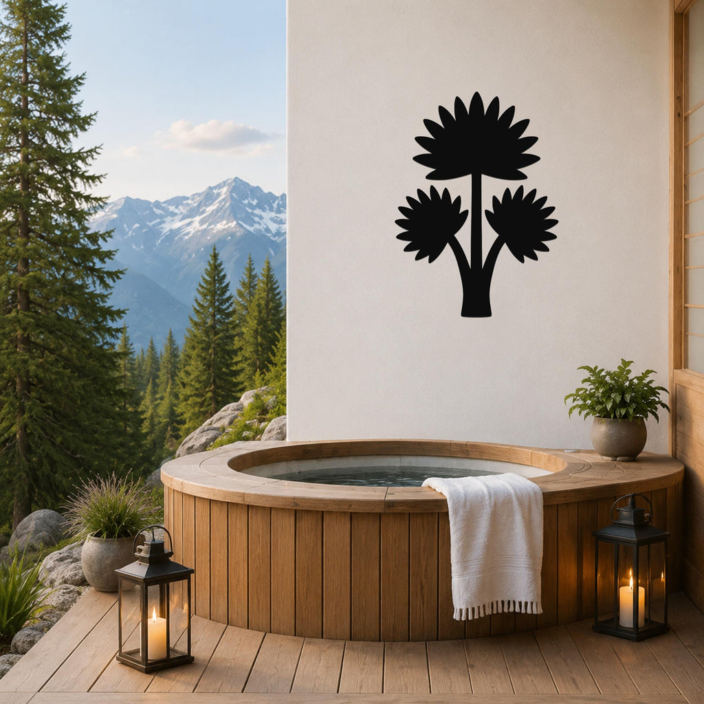 Black metal wall art featuring a fan palm tree silhouette with three leafy fronds, mounted on a white wall above a wooden hot tub on a patio with mountain views.