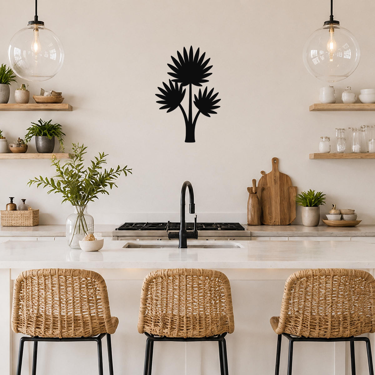 Black metal wall art silhouette of a fan palm tree with three fronds, mounted on a kitchen wall above a counter.