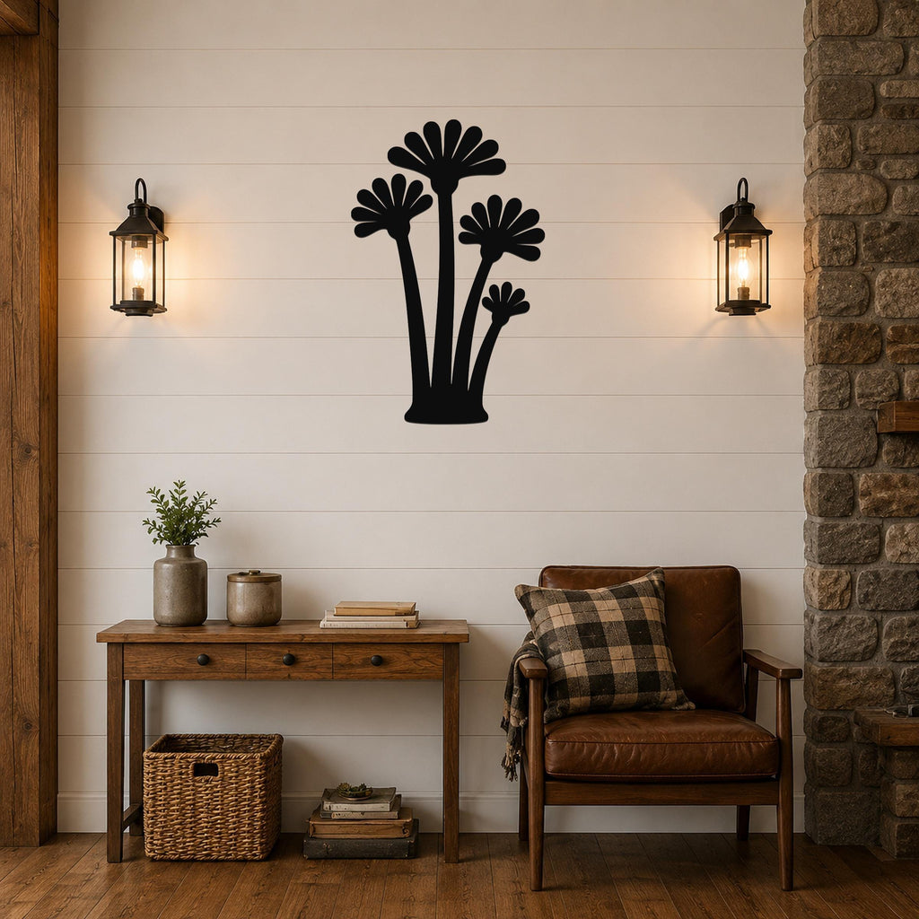 Black metal wall art cutout of three fan palm trees, mounted on a shiplap wall above a wooden console table in a living room.