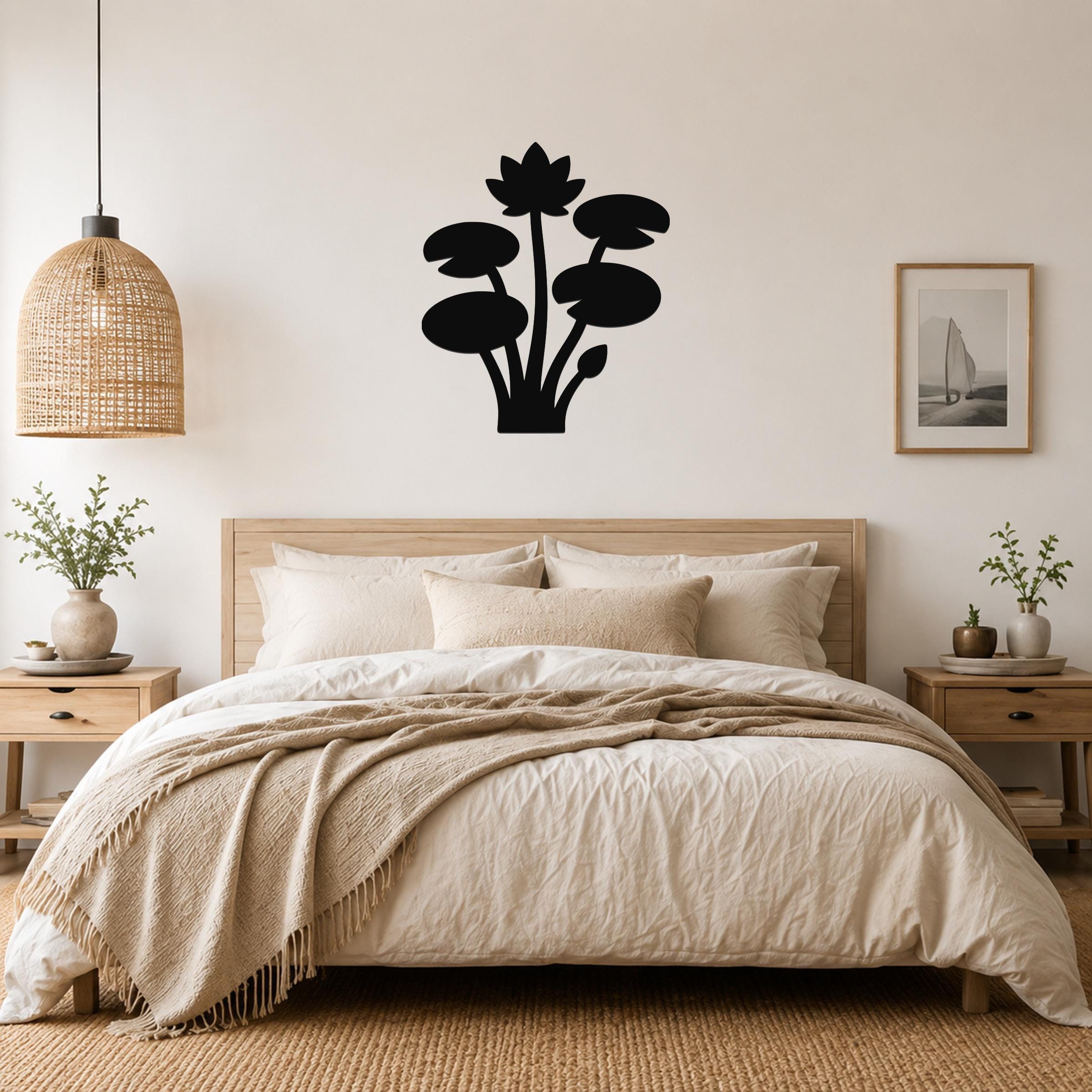 Black metal lotus and water lily wall art silhouette mounted above a wooden bed in a neutral bedroom.