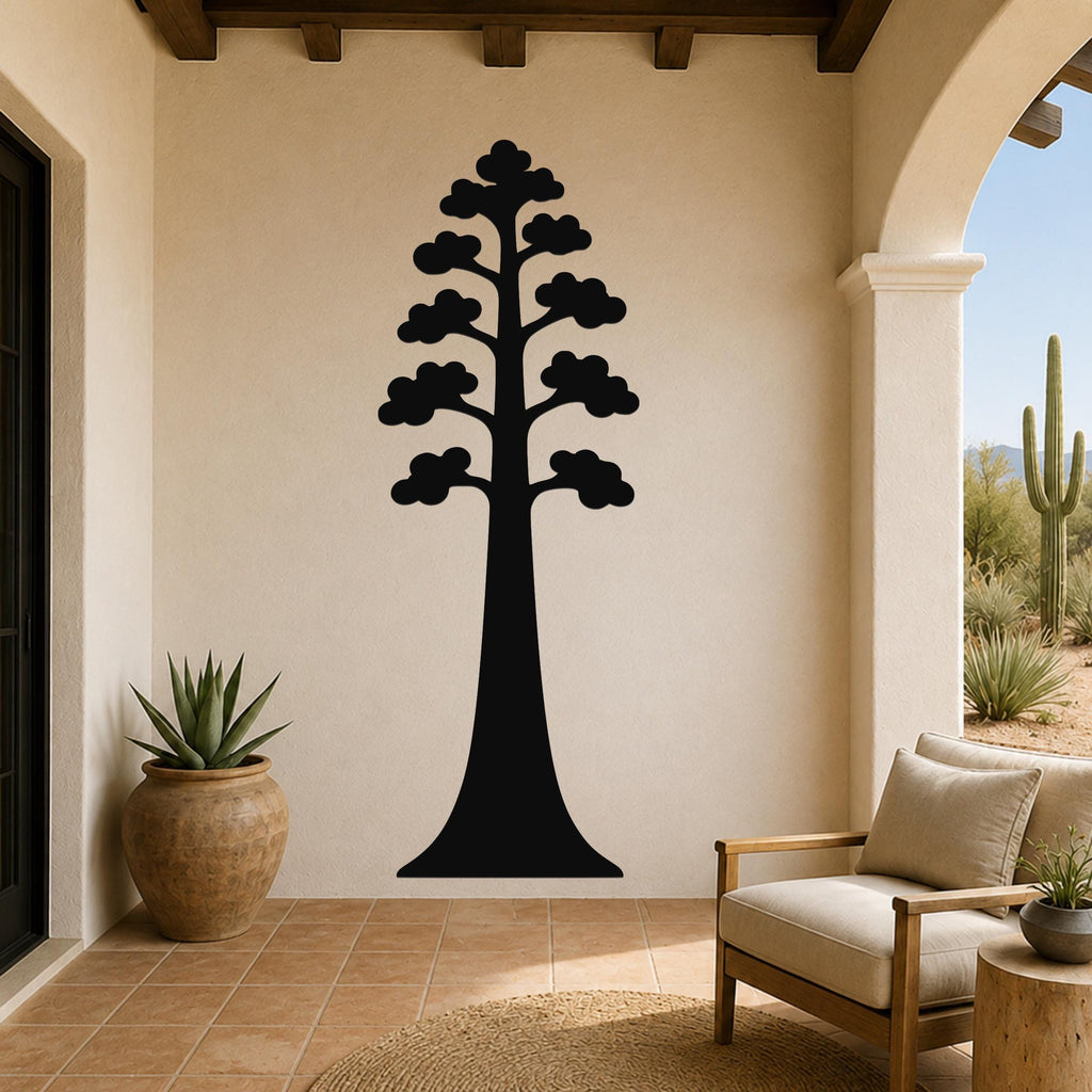 Black metal wall art of a sequoia tree silhouette with layered branches, mounted on a beige stucco wall in a patio living area.