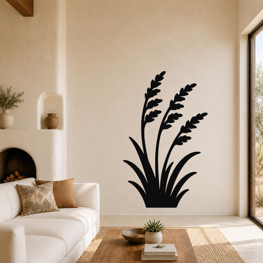 Black metal wall art in a wild grass silhouette design, mounted on a living room wall above a sofa.