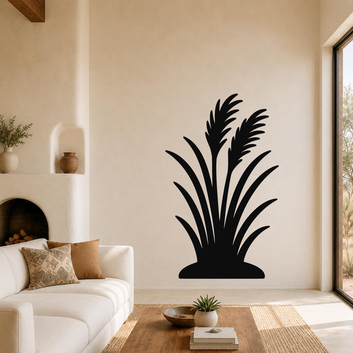 Black metal wall art in a wild grass silhouette design, mounted on a living room wall above a sofa.