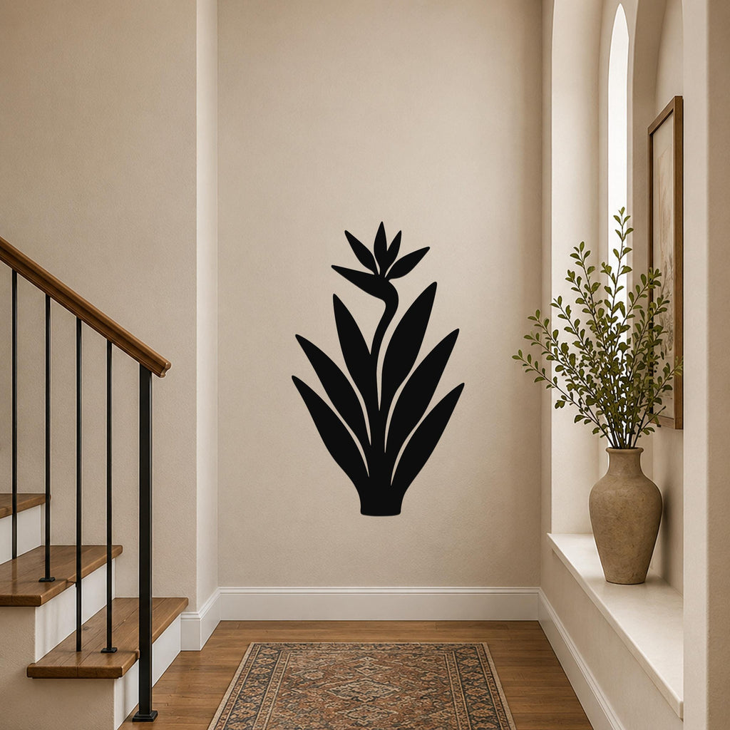 Black metal Bird of Paradise wall art silhouette with leaf and flower cutouts, mounted on a hallway wall above a patterned rug.