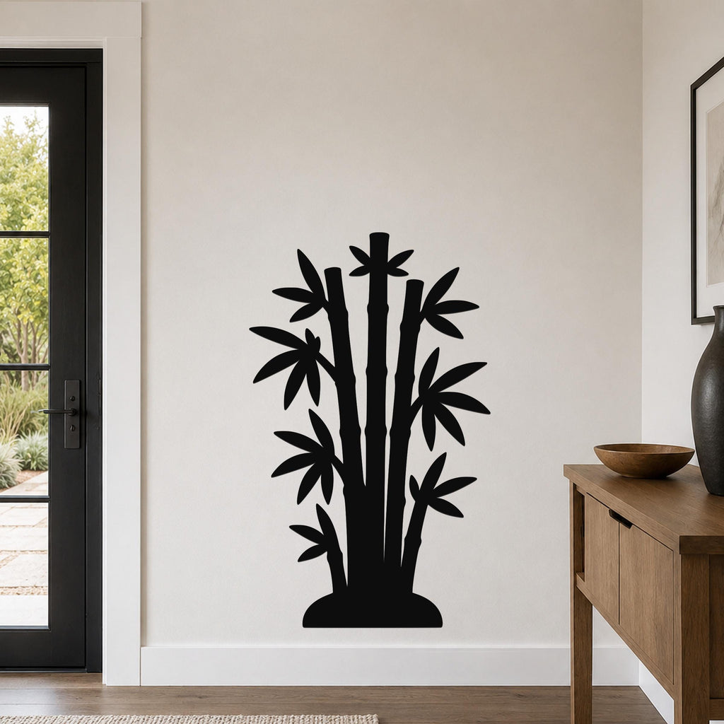 Black metal bamboo wall art with leaf and stalk cutouts, mounted on a light-colored wall in a modern entryway.