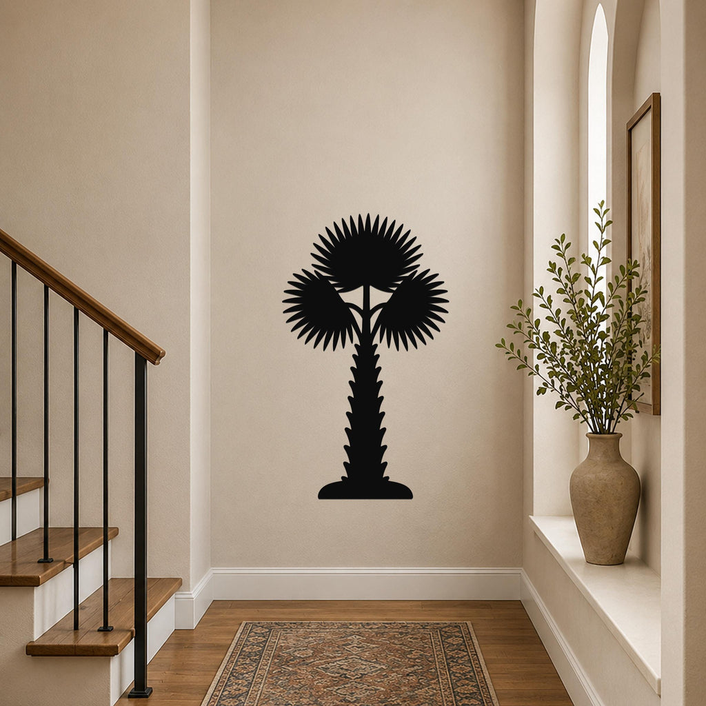 Black metal palm tree wall art with fan-shaped fronds and a textured trunk, mounted on a hallway wall above a patterned rug.