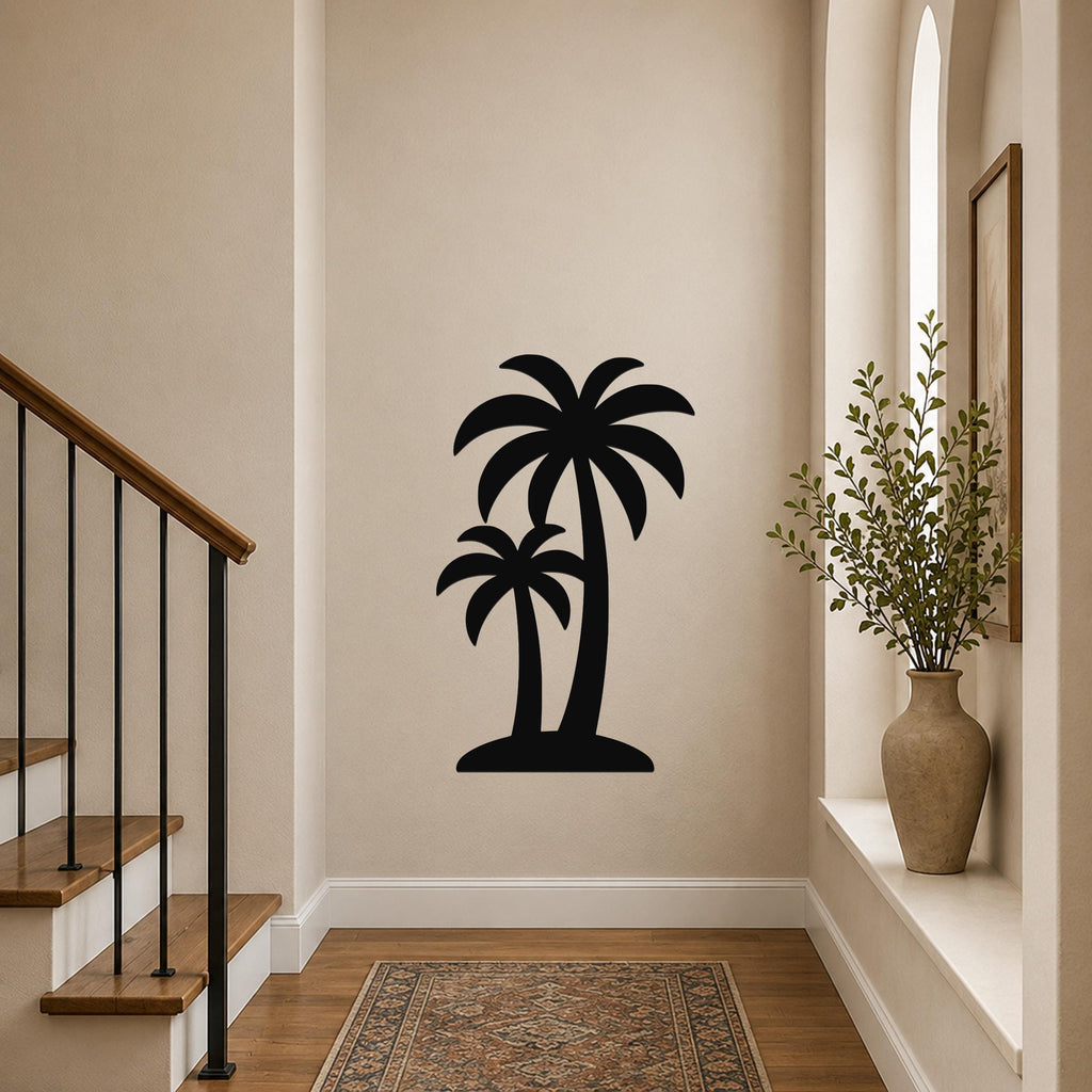 Black metal wall art featuring a silhouette of two palm trees, mounted on a hallway wall above a patterned rug near a staircase.