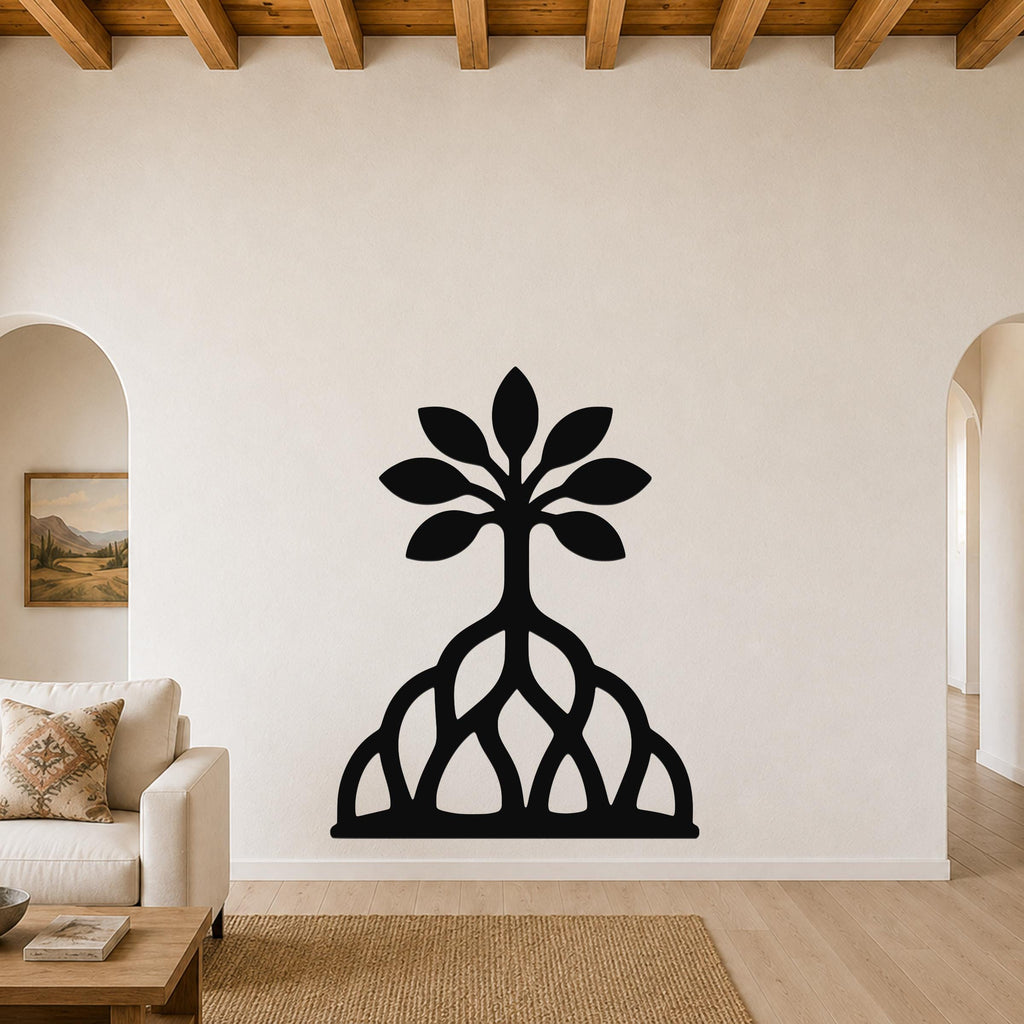 Black metal wall art in a tree silhouette with leafy canopy and exposed root cutouts, mounted on a living room wall above a sofa.