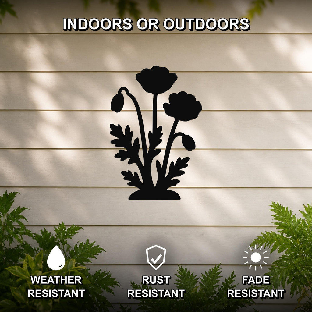 Black metal poppy wall art silhouette with detailed flower and leaf cutouts, mounted on a light-colored outdoor wall with greenery, weather, rust, and fade resistant.
