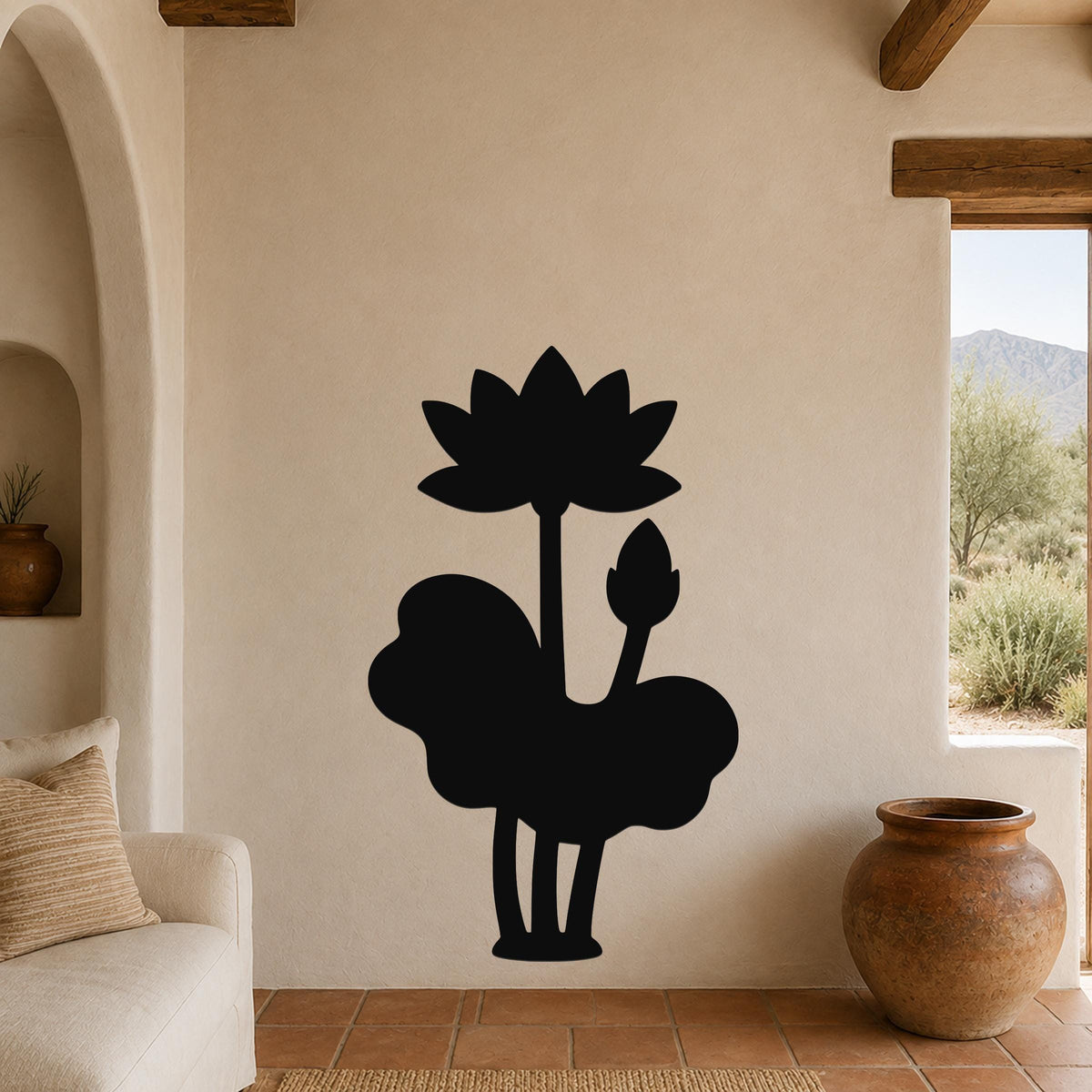 Black metal wall art silhouette of a lotus flower and leaves, mounted on a beige living room wall above a sofa.