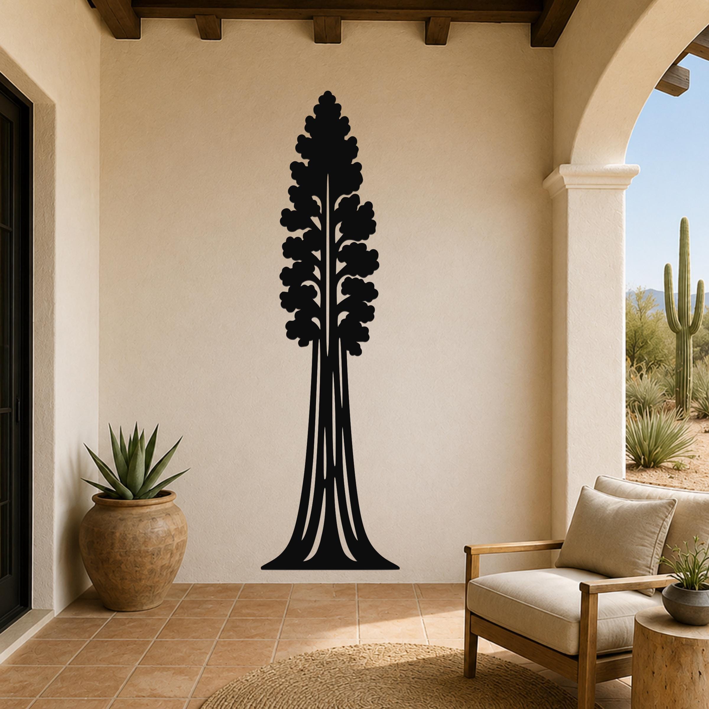 Black metal sequoia tree wall art with detailed branch cutouts, mounted on a beige stucco wall in a patio living space.