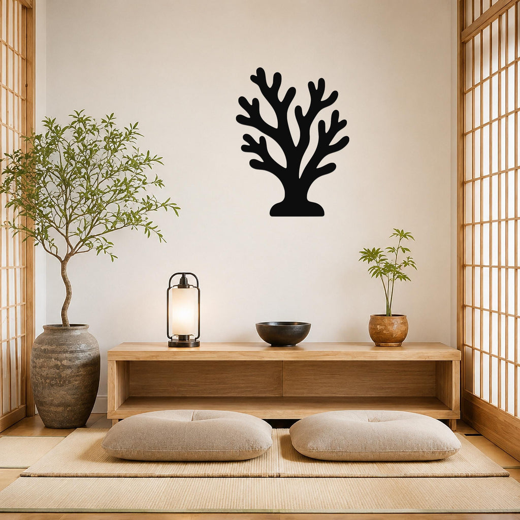 Black metal coral wall art with branching cutouts, mounted on a white shiplap wall above a wooden bench on a porch.