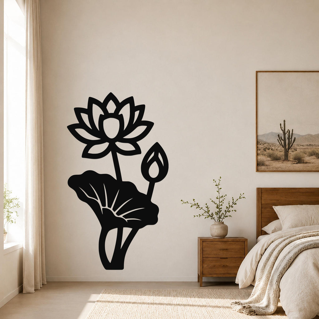 Black metal lotus flower wall art with a large bloom, bud, and leaf cutouts, mounted on a bedroom wall above a nightstand.