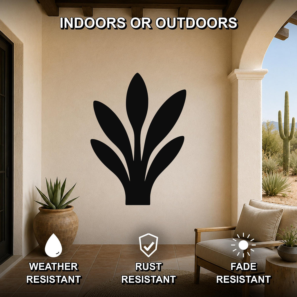 Black metal snake plant wall art with leaf cutouts, mounted on a beige outdoor patio wall above a chair and potted plant.
