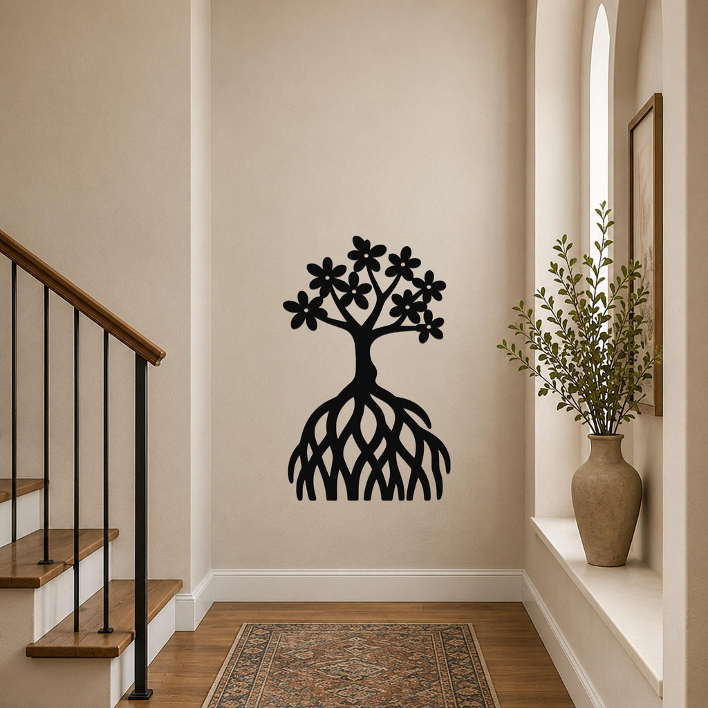 Black metal wall art cutout of a tree with flowers and exposed roots, mounted on a hallway wall above a patterned rug.